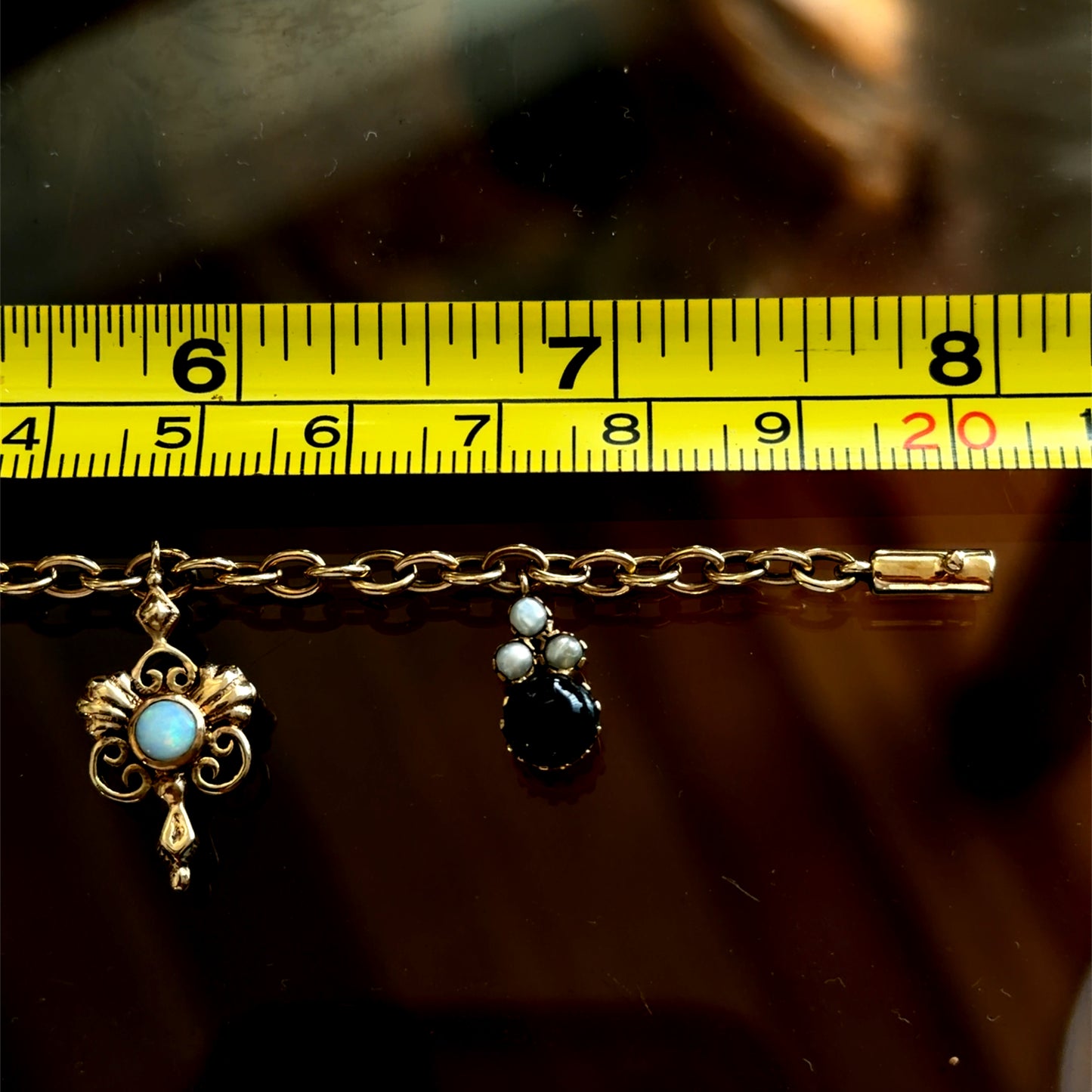 A Spectacular Victorian 9k Yellow Gold Charm Bracelet Having Sapphire, Pearl, Garnet, Aqua & Peridot Articulated Charms. 8” in Length.