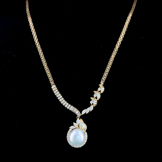A Stunning 18k Yellow Gold 11mm South Sea Pearl Set With Marquise Round & Baguette Diamond Pendant Suspended on An Exquisite Byzantine Chain. Appx 1.65 Cts F/G VS-Si Part Of The Ronald Charles Collection