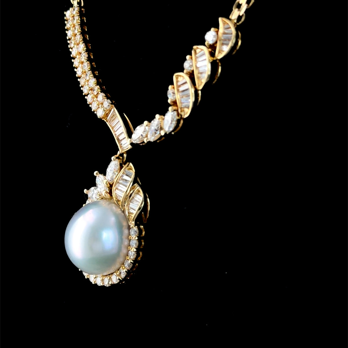 A Stunning 18k Yellow Gold 11mm South Sea Pearl & Diamond Pendant Suspended on A Byzantine Chain. Appx 1.65 Cts Marquise,Round Cut & Baguette Diamonds of F-G Colour VS- Si1 Clarity. Part Of The Ronald Charles Collection.