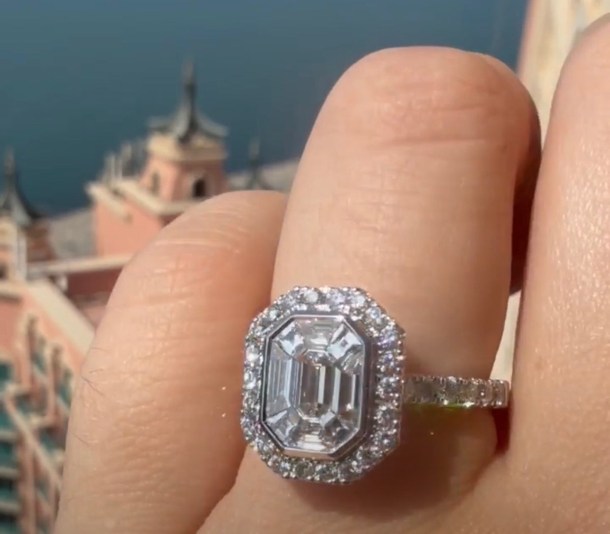 18k White Gold Emerald Cut Segmented Diamond Halo Ring 1.5 Ct Central And 1Ct of Diamonds Surrounding.