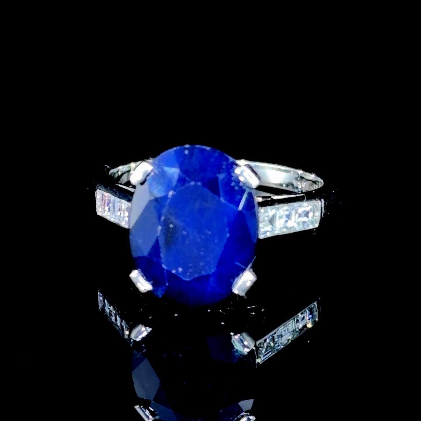 A Beautiful Platinum Ring Having A Wonderful Mid Blue Sapphire of Appx 5 Cts Flanked By Asscher Cut Diamonds of Appx 0.6 Cts to The Shoulders