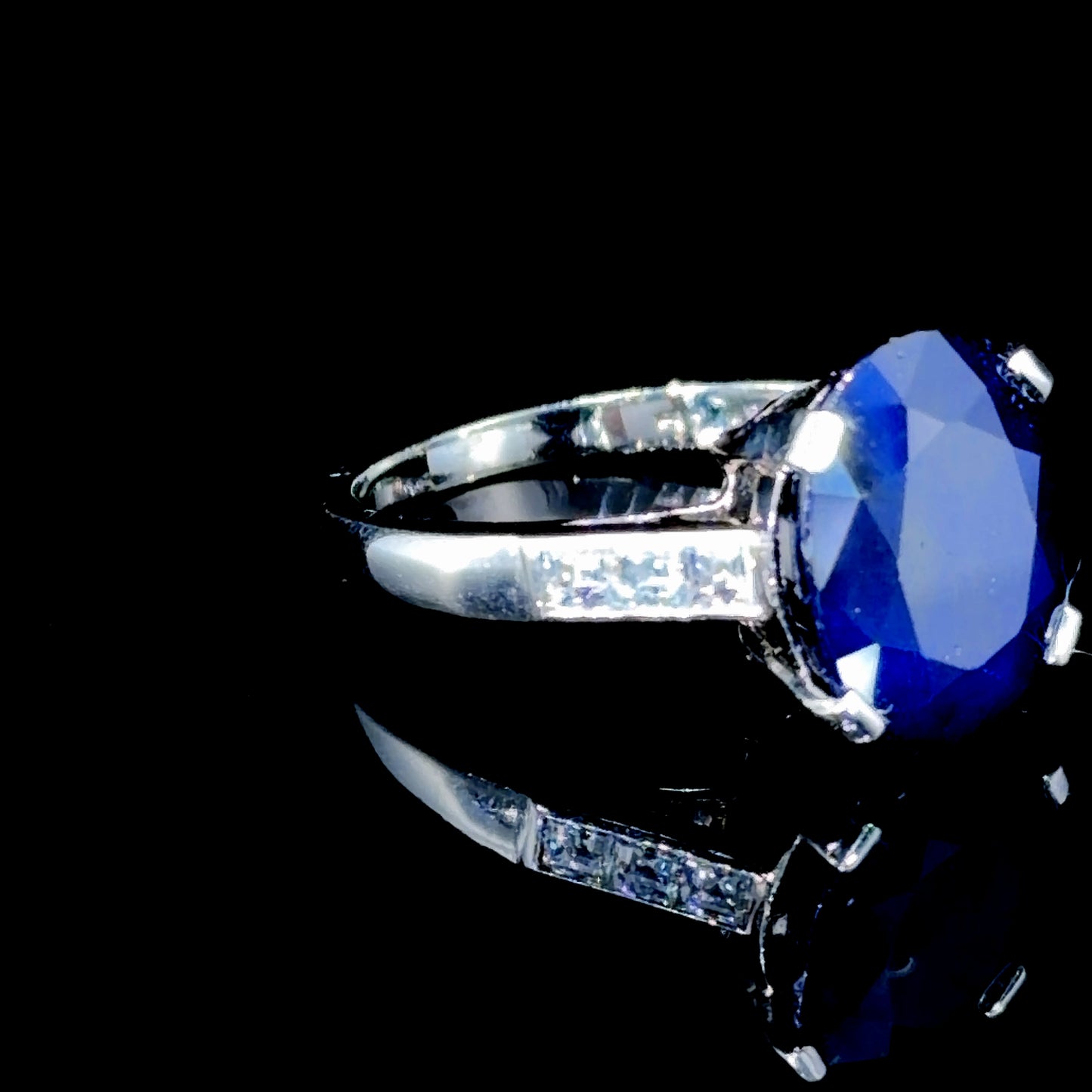 A Beautiful Platinum Ring Having A Wonderful Mid Blue Sapphire of Appx 5 Cts Flanked By Asscher Cut Diamonds of Appx 0.6 Cts to The Shoulders