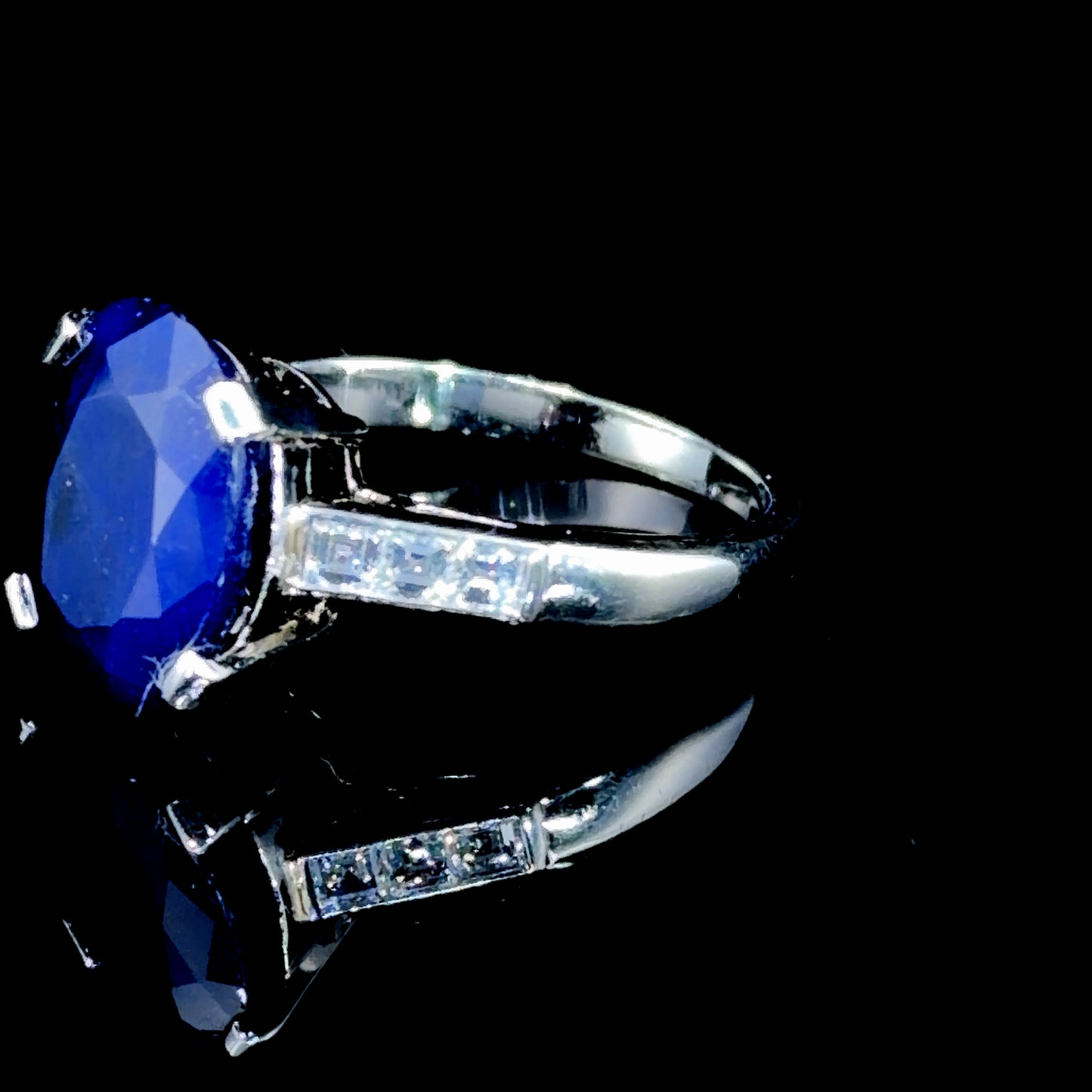 A Beautiful Platinum Ring Having A Wonderful Mid Blue Sapphire of Appx 5 Cts Flanked By Asscher Cut Diamonds of Appx 0.6 Cts to The Shoulders