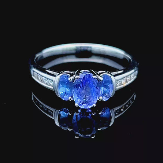 9K White Gold Tanzanite Trilogy Ring With Channel Set Diamonds To Shoulders