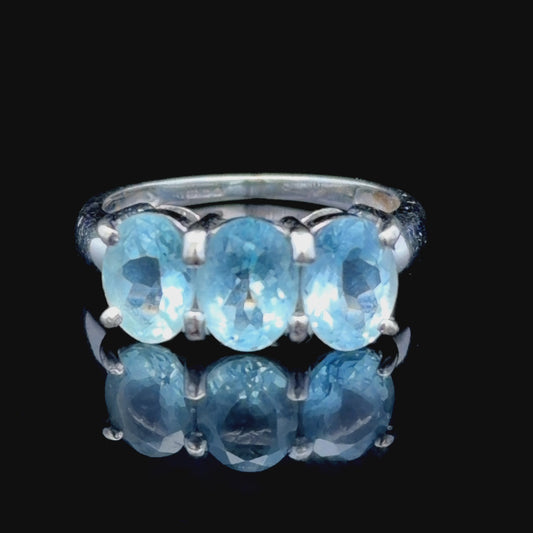 9k White Gold Oval Blue Topaz Trilogy Ring