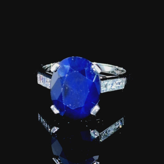 A Beautiful Platinum Ring Having A Wonderful Mid Blue Sapphire of Appx 5 Cts Flanked By Asscher Cut Diamonds of Appx 0.6 Cts to The Shoulders